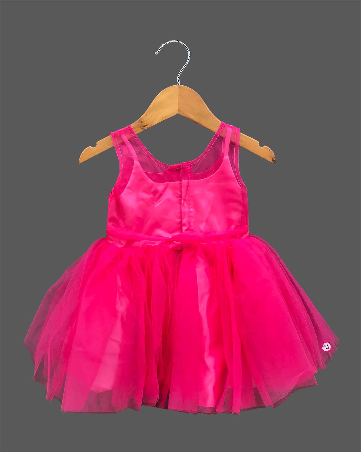 Sleeveless party outfit for toddlers with layered tulle skirt and handcrafted rosette chest appliques.