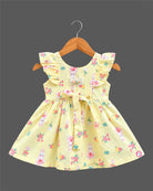 Toddler girl printed cotton A-line frock featuring ruffle shoulders, waist tie bow, and delicate lace badge accent.