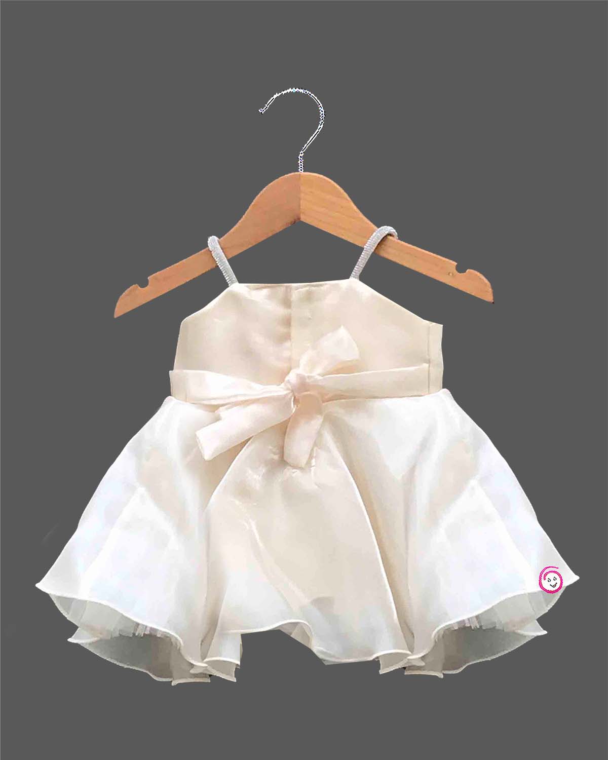 Off-white satin and organza party frock for baby girls featuring a large satin rose, embroidered leaf detail, and pearl embellishments