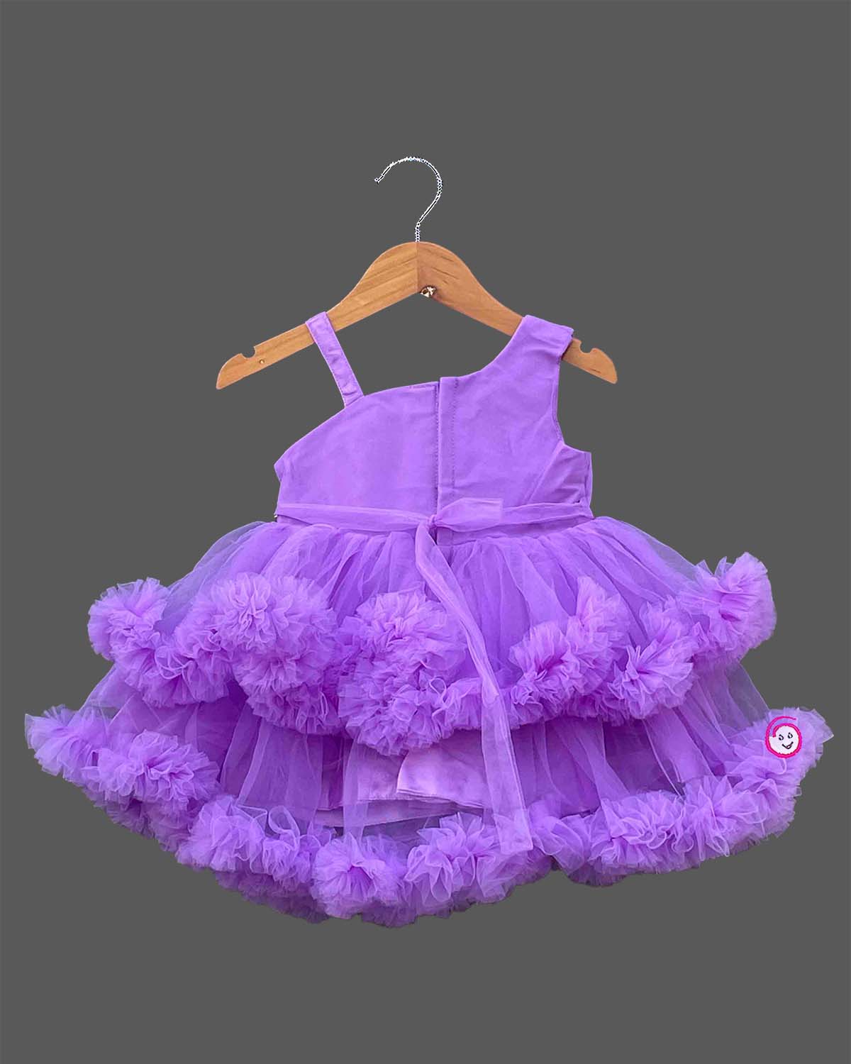 Purple net frock with layered ruffles and floral embellishment for girls