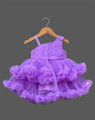 Purple net frock with layered ruffles and floral embellishment for girls