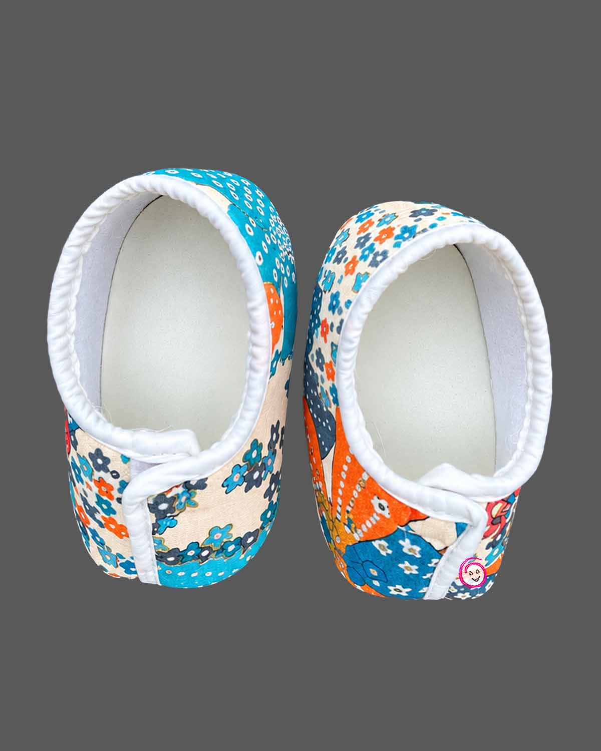 Toddler wearing an asymmetric floral print kids dhoti kurta with mandarin collar and pleated bottoms.