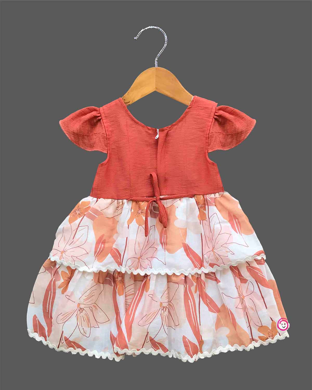 Little girl tiered printed casual frock with cap sleeves and floral crochet applique