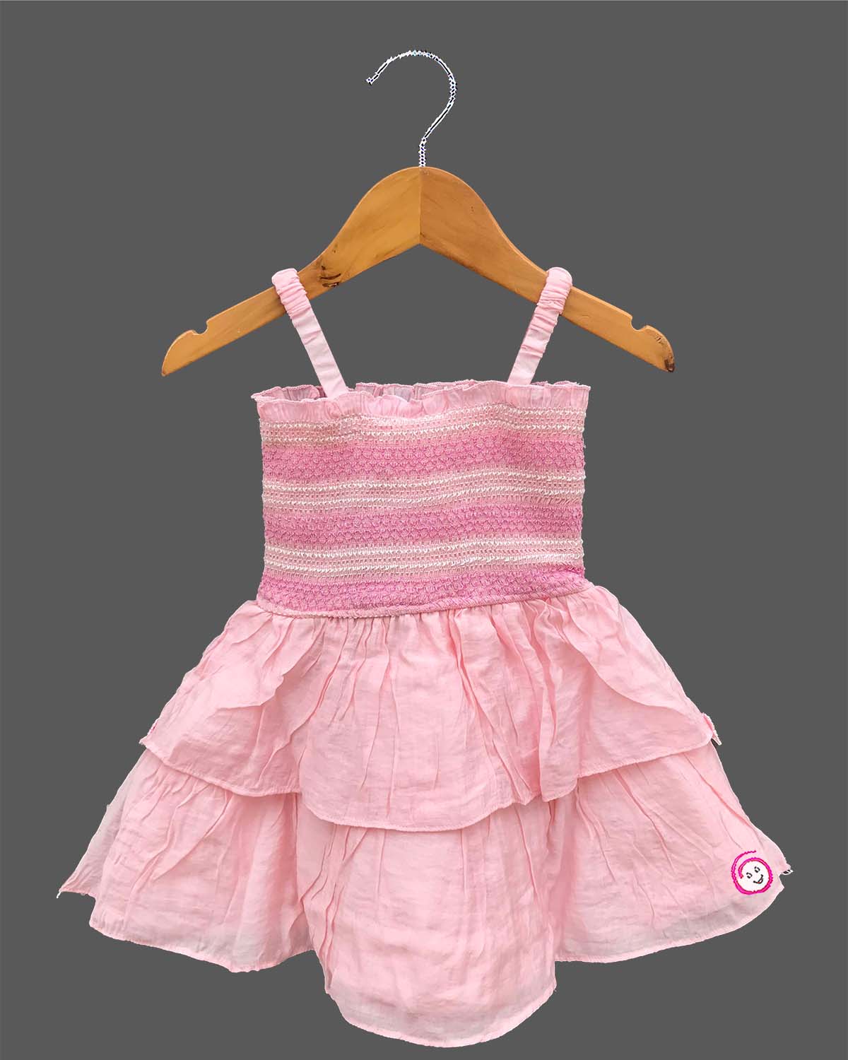 Strapless style smocked bodice frock with detailed flower applique and ruffled lace hem for a little princess
