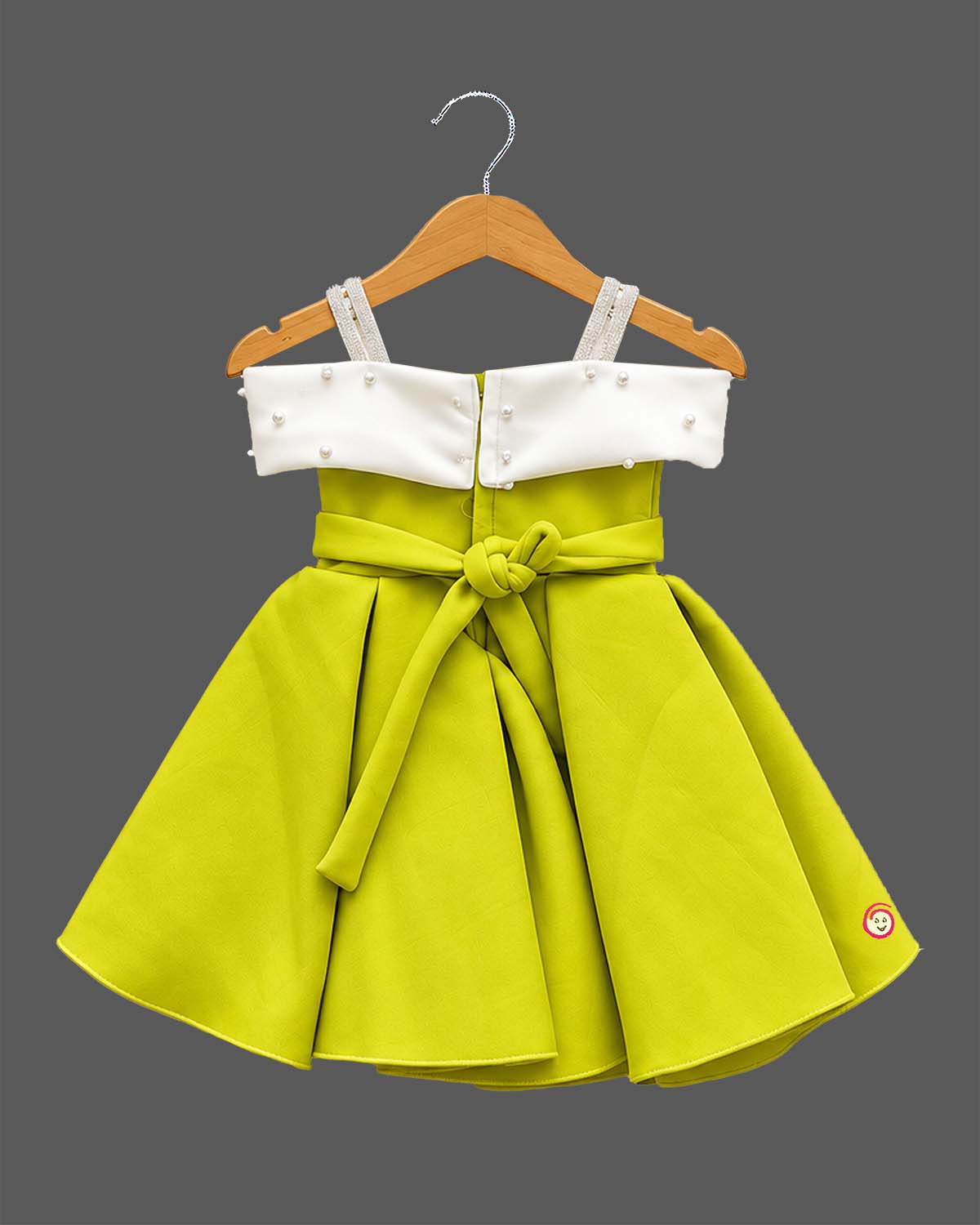 Off-shoulder bow design silk frocks for baby girl with box pleats and pearl tassel details.