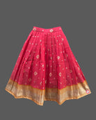Three-piece ethnic traditional outfit for girls comprising an embroidered top with puff sleeves, a pleated zari skirt, and a light dupatta.