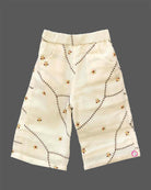 A cute patterned cotton co-ord set for baby girls featuring a sleeveless peplum top with ruffle straps and matching pants on a hanger.