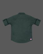 Front view of a smart collared casual shirt for toddler boys featuring roll-up sleeves and button closures against a solid background.