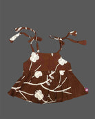 Stylish sleeveless cotton spaghetti top for baby girls with embroidered floral patterns and shoulder tie straps.