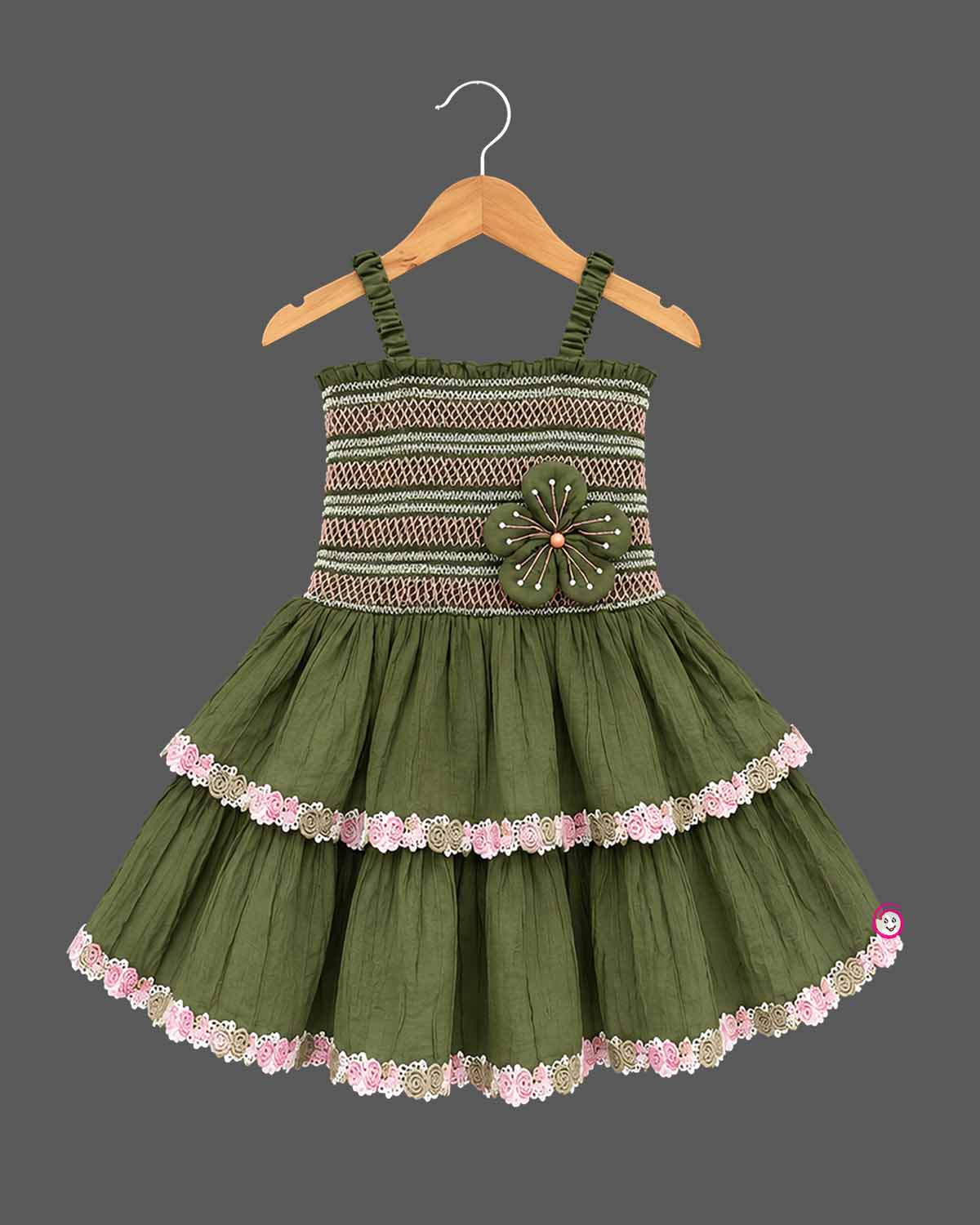 Baby party wear dress with smocked elastic bodice, tiered flared skirt, and delicate lace trim.