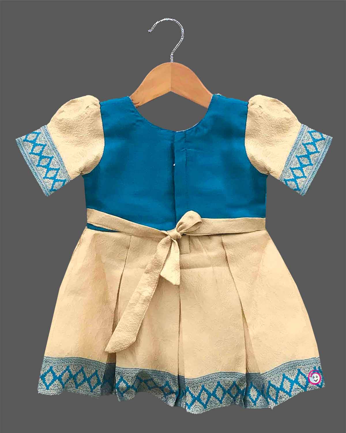 Kids silk ethnic frock featuring floral hand embroidery and woven zari border for traditional parties