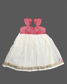 Toddler traditional ethnic wear frock with woven Kasavu pattern and floral detail for festivals.