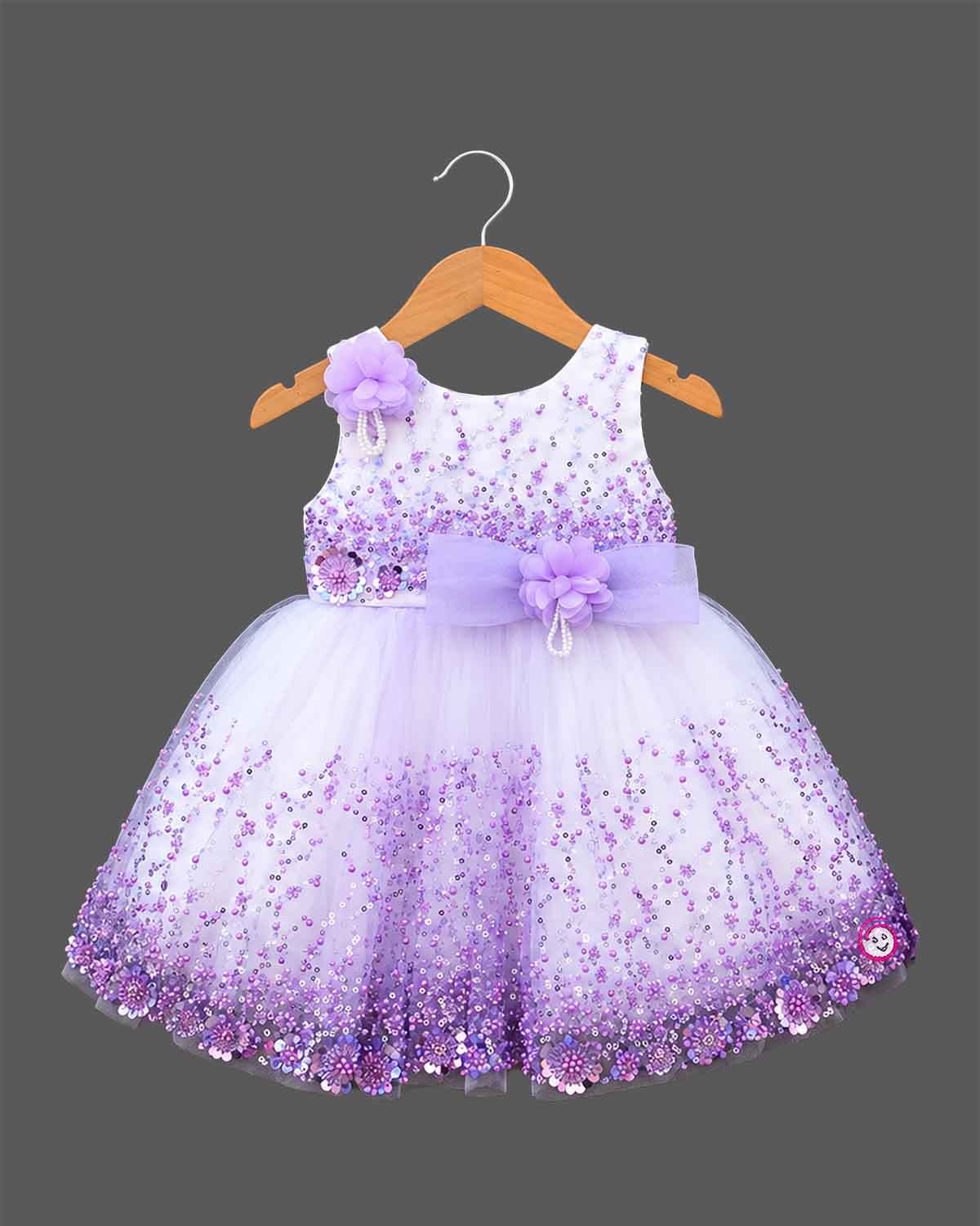 Girls sleeveless sequin embellished tulle flared frock with waist bow appliqué and round neck.