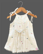 Little girl embroidered cotton frock with round neck and ribbon shoulder tie ups for birthday party and summer gathering