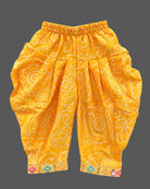 Sleeveless bandhani print short kurti with mirror work yoke paired with pattu langa for kids dhoti pants.