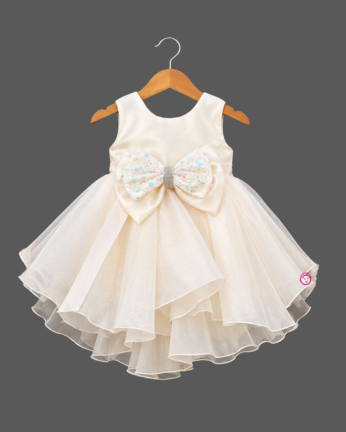 Silk frocks for baby girl featuring multi-layered organza ruffles and a jeweled bow.
