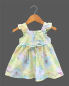 Sleeveless floral printed Schiffli cotton dress for toddlers with ruffled shoulder straps and a chest bow detail.