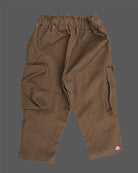Casual utility cargo pant for young prince designed with dual flap pockets, graphic patch accent, and a thick rope drawstring waistband.
