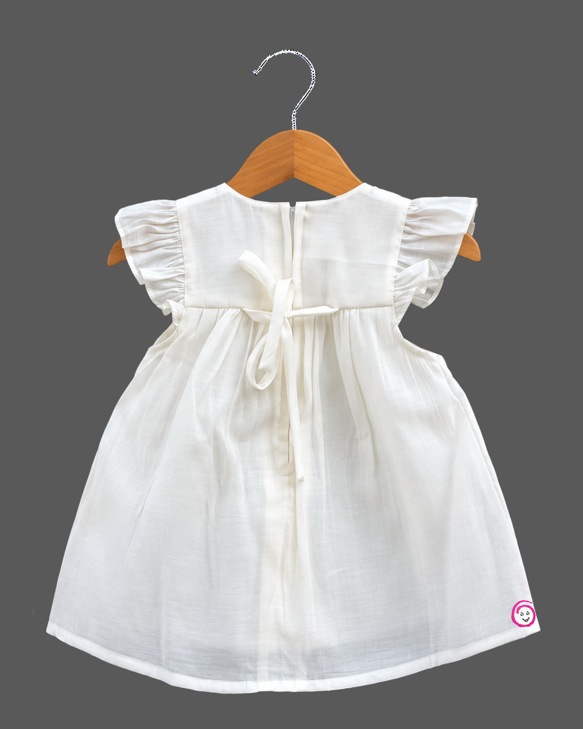 Baby girl cotton frilled frock with embroidered botanical hem and cap sleeves