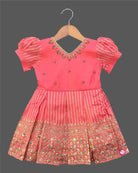 Infant cotton silk frock in peach pink with gold zari work and neckline embroidery for ear piercing ceremonies, festivals, temple visits, and weddings  