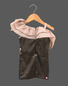 One shoulder girls toddler sequin party dress with light brown shoulder ruffle, black sequin body, and a black rose detail, hanging on a wooden hanger against a dark grey background, with a small OPUS RKID logo in the corner.
