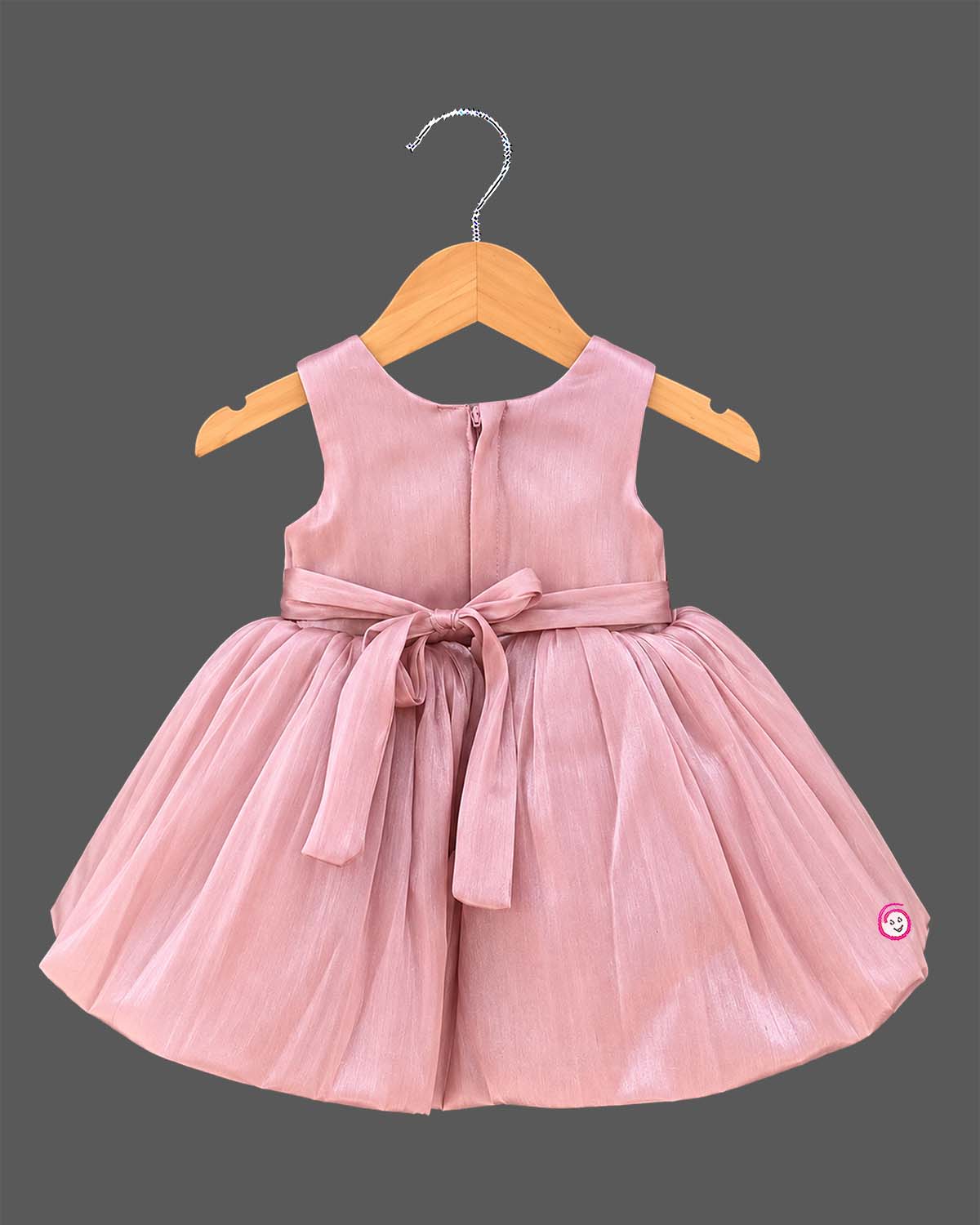 Dusty rose pink toddler net party frock featuring a large floral applique and sleeveless design for girls.