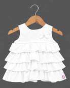 White tiered ruffled baby girl party wear frock with butterfly applique for birthdays, weddings, and special occasions