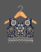 Girls sleeveless embroidered choli lehenga set with beaded fringe hem, tassel drawstring, and pleated flared skirt.