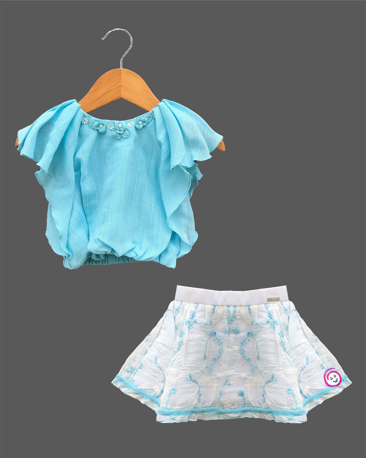 Trendy flutter sleeve top paired with an embroidered A-line skirt, a stylish party attire for toddlers and young fashionistas.