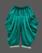 Sleeveless short kurti with attached embroidered jacket and pleated dhoti patiyala pants for kids[cite: 5].