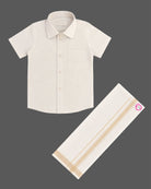 Little gentleman wearing traditional cotton shirt and dhoti for festive occasions
