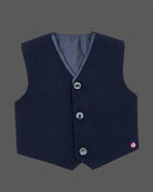 Blue boys formal suit with silver shoulder embroidery, white shirt, and bowtie