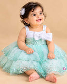 Girls sequin tiered tulle party frock with sleeveless satin shoulder straps and front bow accent under 120 chars.