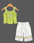 Sleeveless embroidered top with butterfly motifs and matching pleated pants with scalloped hems
