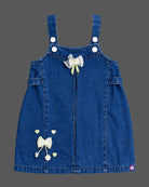 Baby party wear dress featuring a denim pinafore with bow embellishments and ribbed inner top for toddlers.