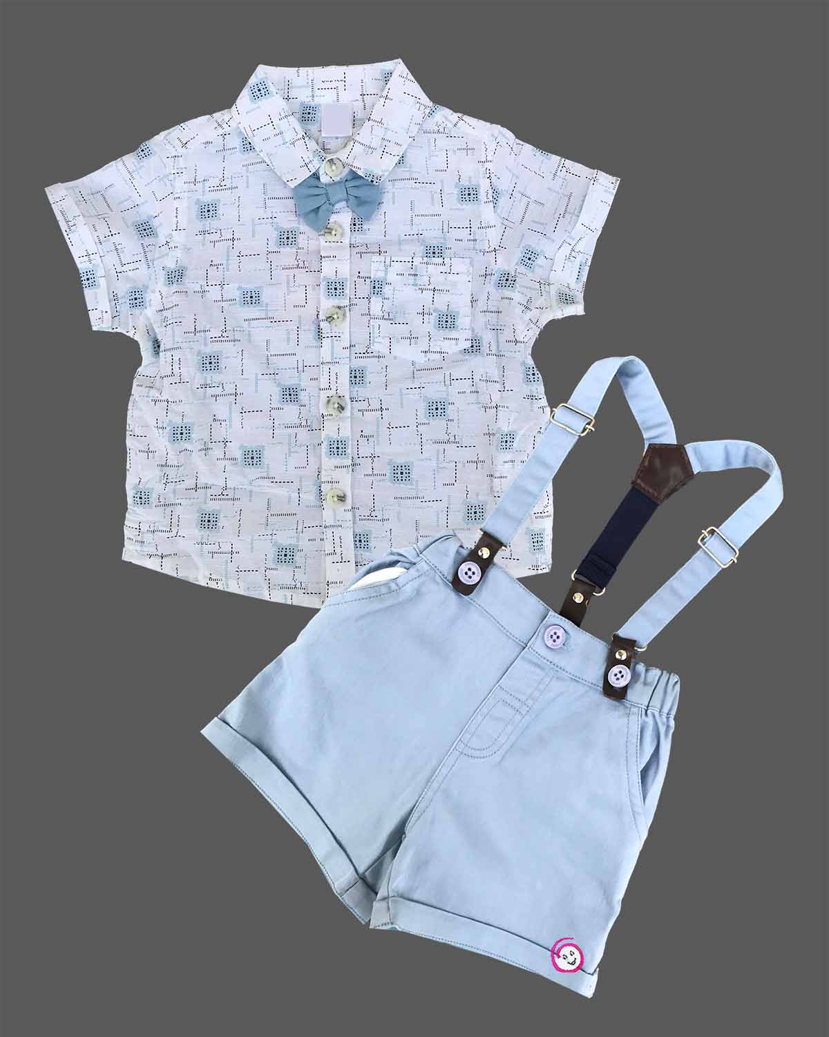 Stylish young boy's printed shirt with a blue bow tie and coordinating suspender shorts set.