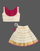 A sleeveless top with a checkered patch and a gold-striped skirt for Onam traditional wear.