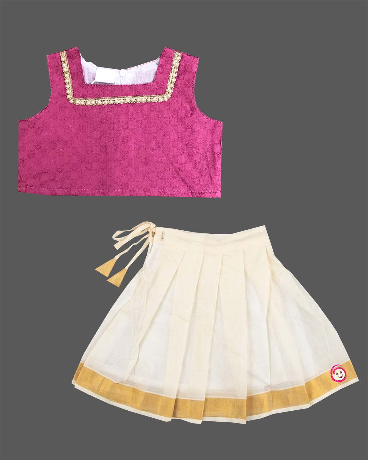 Little fashionista traditional two-piece festive choli set with woven zari borders and pleated ethnic skirt.