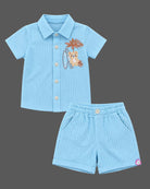 Co-ord set for baby boy featuring button-down collar shirt and short set with embroidered bear applique.