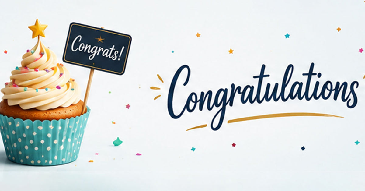 A cupcake with cream frosting, colorful sprinkles, and a small black sign on top that says 'Congrats!' beside large decorative 'Congratulations' text on a white background with scattered confetti.
