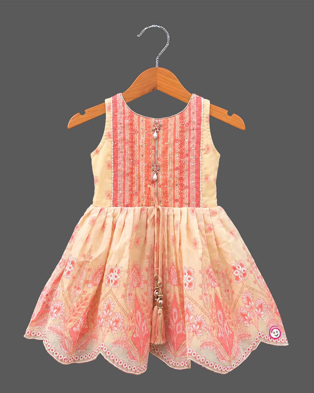 Girls printed short kurta with scalloped hem and matching tiered flared sharara pants for ethnic wear.