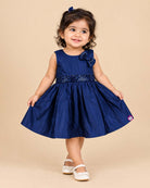 Sleeveless A-line frock with sequined waist belt and shoulder bow, styled as a baby casual wear dress.