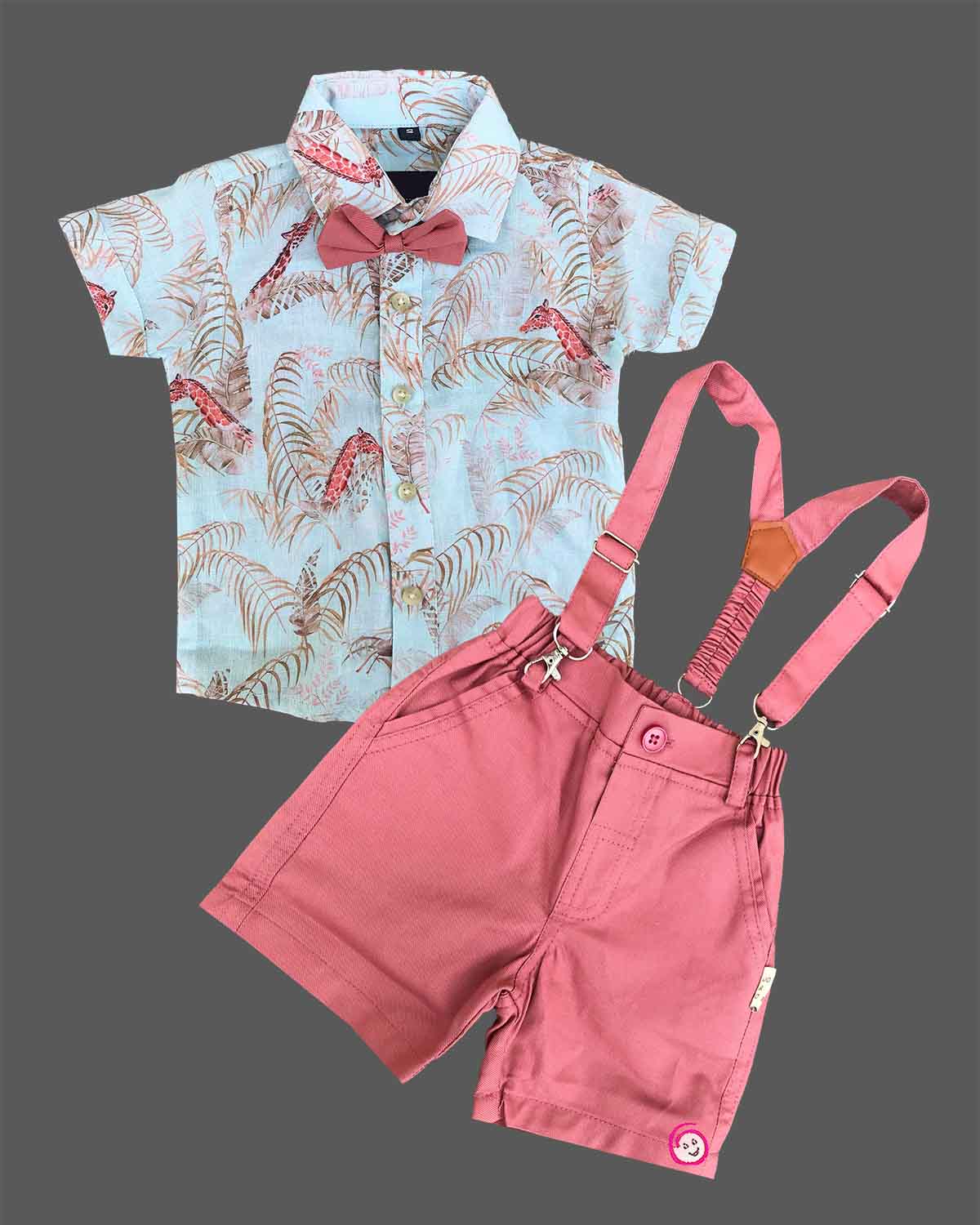 Dapper toddler boys ethnic ensemble featuring a collared printed shirt with a bow tie and matching suspender shorts.