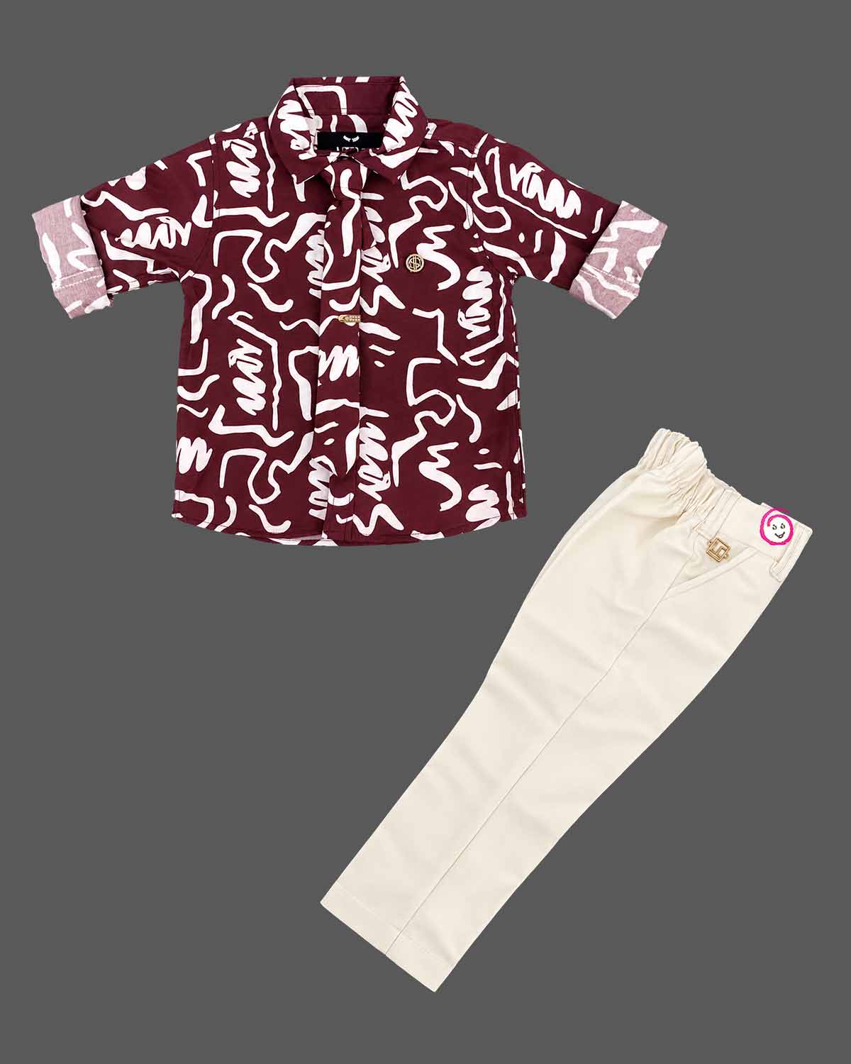 Abstract printed short sleeve shirt and tailored trousers party wear for boys set with elastic waist.