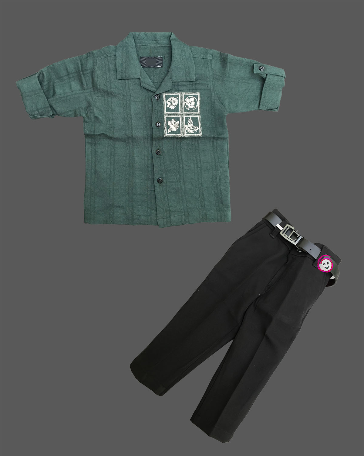 Dapper two-piece set for little gentleman featuring a textured notch-collar shirt with embroidered chest patches, paired with tailored pant and a buckle belt.