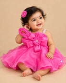 Girls organza party frock featuring oversized front bow appliqué and flared hem silhouette.
