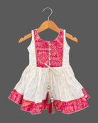 Sleeveless printed short kurta and flared tiered kids sharara set with gota trim details.