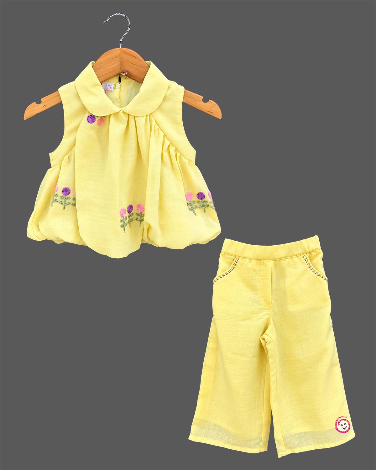 Sleeveless peter pan collar bubble top with floral embroidery paired with matching straight pant