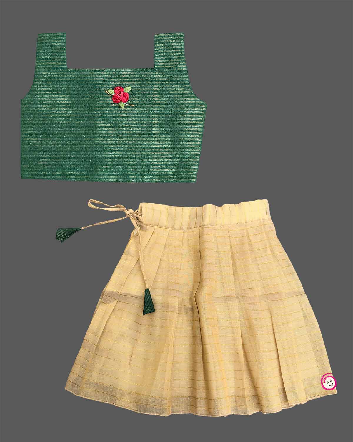 Young fashionista wearing traditional festive two-piece set featuring ribbon rose detail and pleated zari striped skirt.