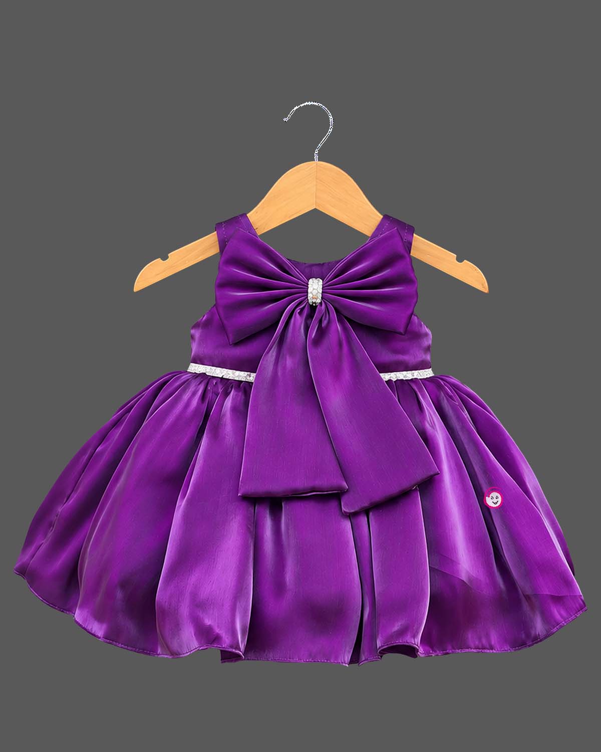 Baby party wear dress featuring a sleeveless satin fit and flare silhouette with front oversized bow and booties set.